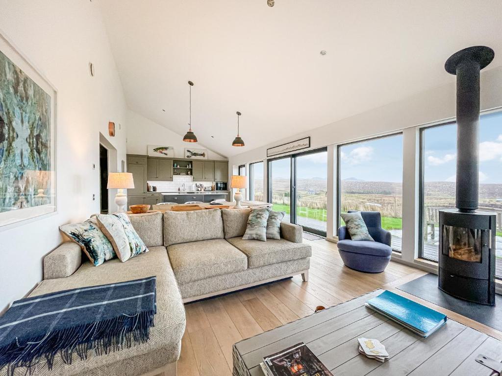 a living room with a couch and a fireplace at Clarsach in Big Sand