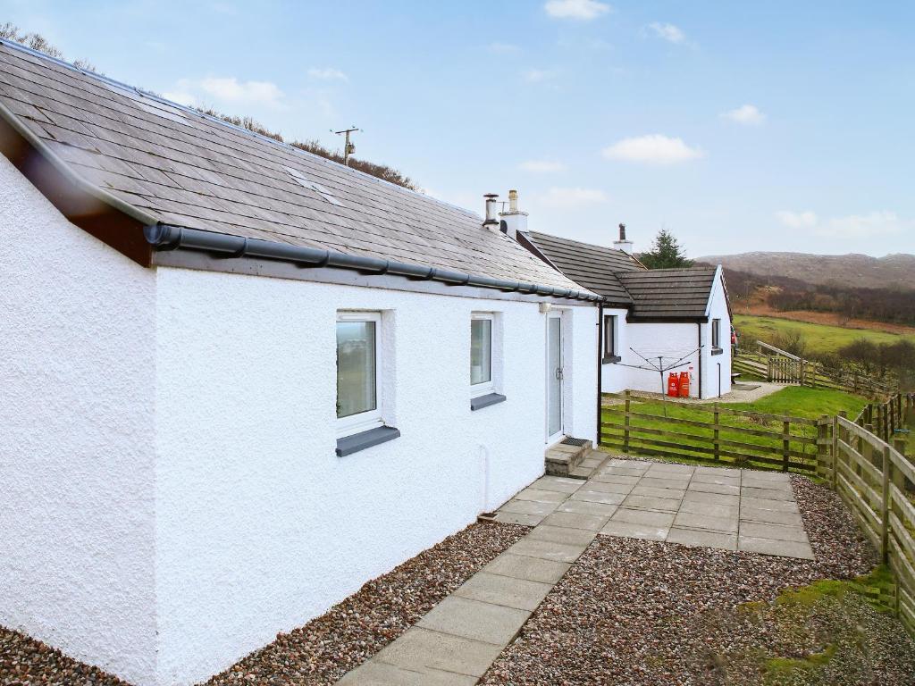 a white house with a pathway in front of it at Dondies House in Kilchoan