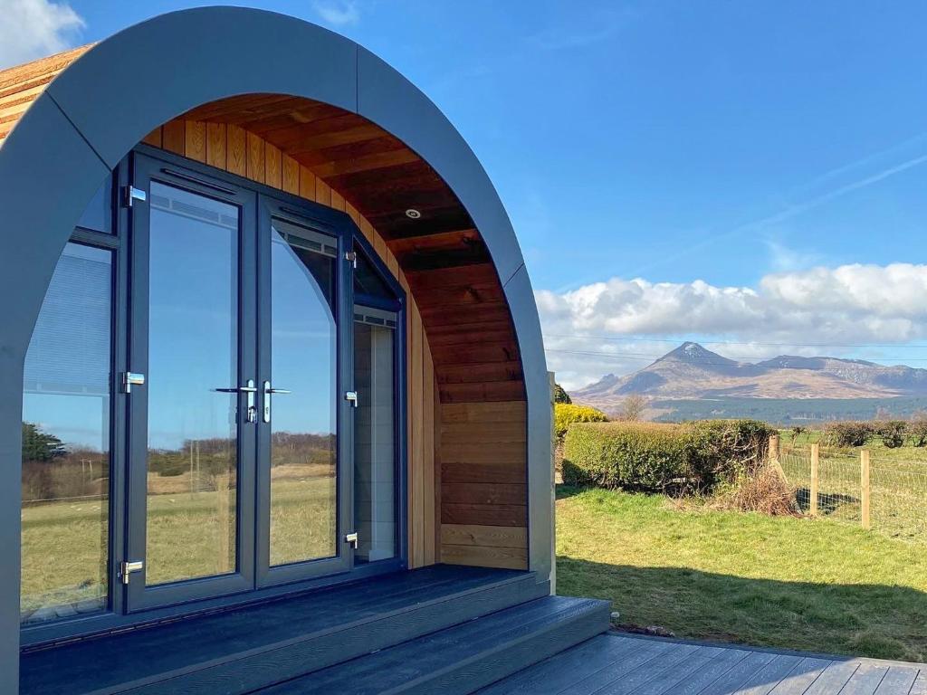 an arched entry to a house with a view of mountains at Dunfion - Uk7835 in Brodick