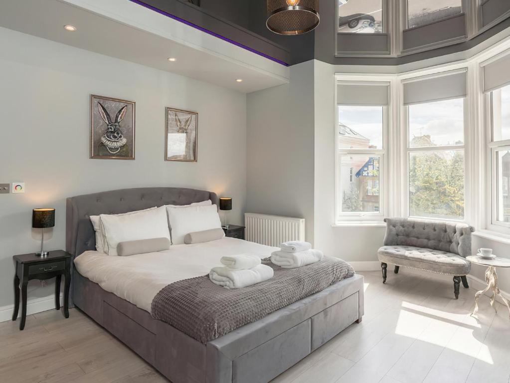 a bedroom with a large bed with towels on it at Coastal Gem - Uk2773 in Llandudno