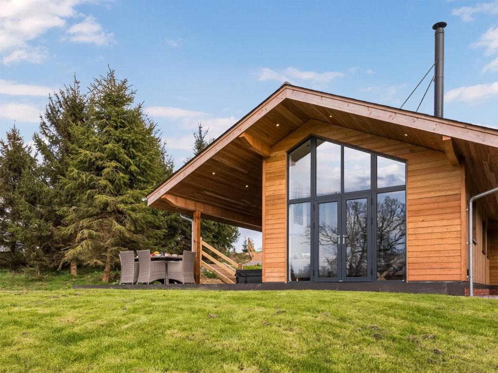 a house with a large window on a grass field at Melbury Lodge - Uk31009 in Ansty