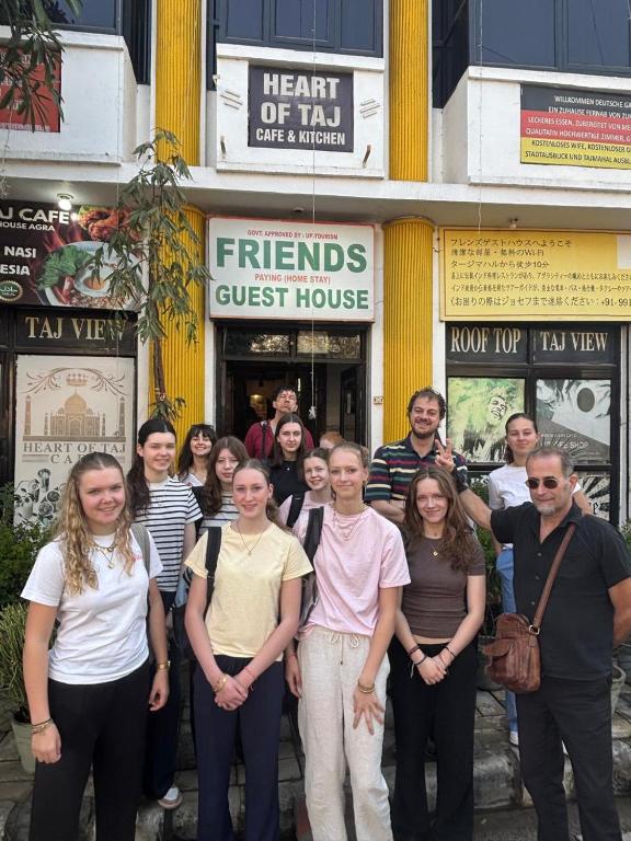 a group of people standing in front of a building at Friends Guest House & Hostel- near TAJ MAHAL in Agra