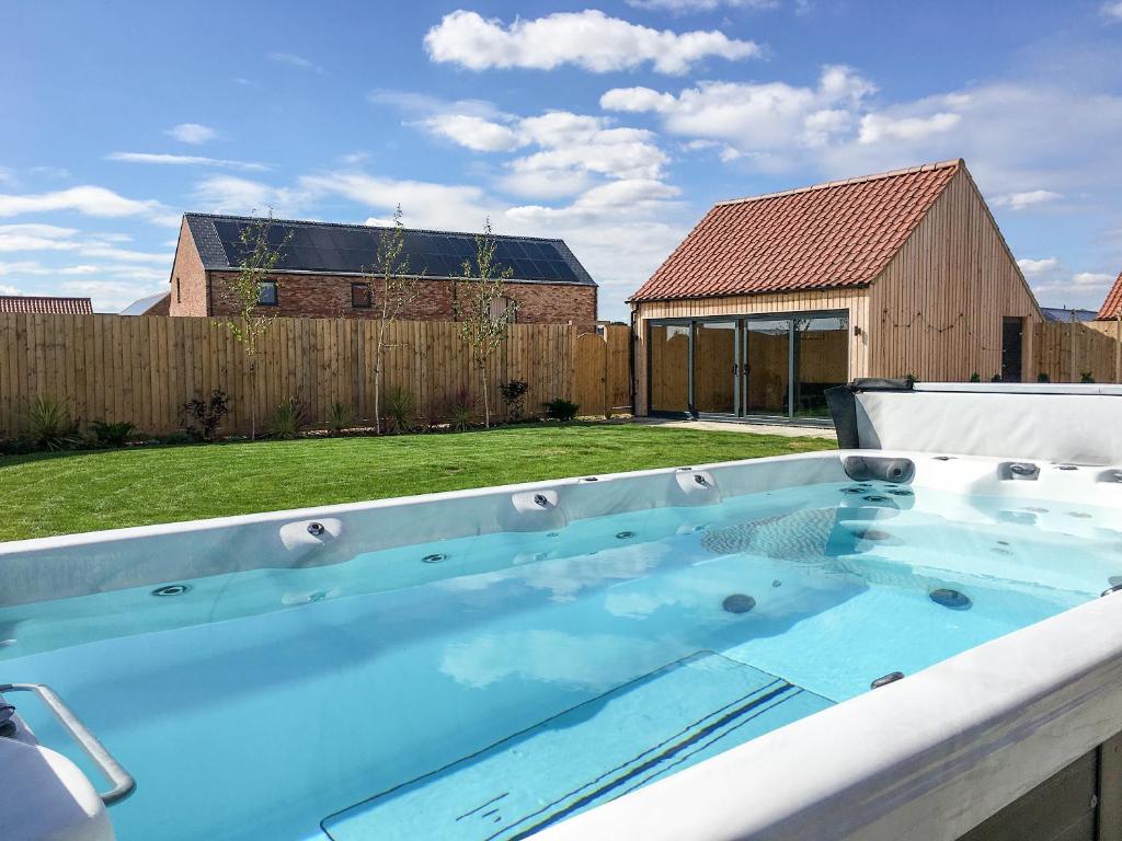a hot tub in the backyard of a house at The Willows - Ukc4617 in Dunholme