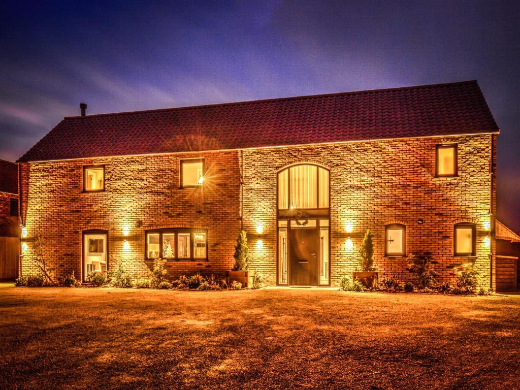a brick house with lights on the front of it at The Elms - Ukc4613 in Dunholme