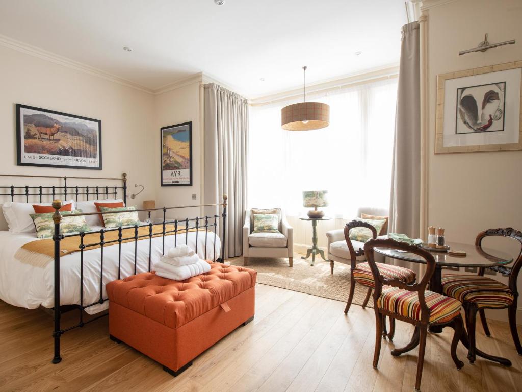a bedroom with a bed and a table and chairs at Running Hare - Uk7558 in Inverness