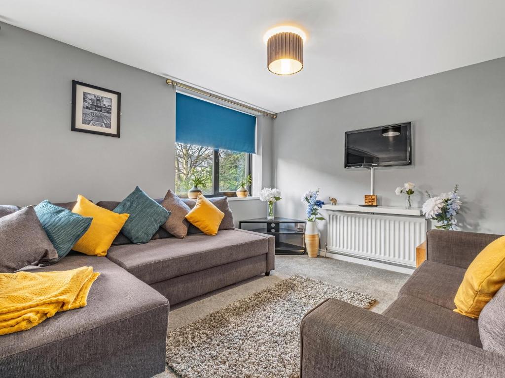 a living room with two couches and a tv at Ouseburn Apartment in Jesmond