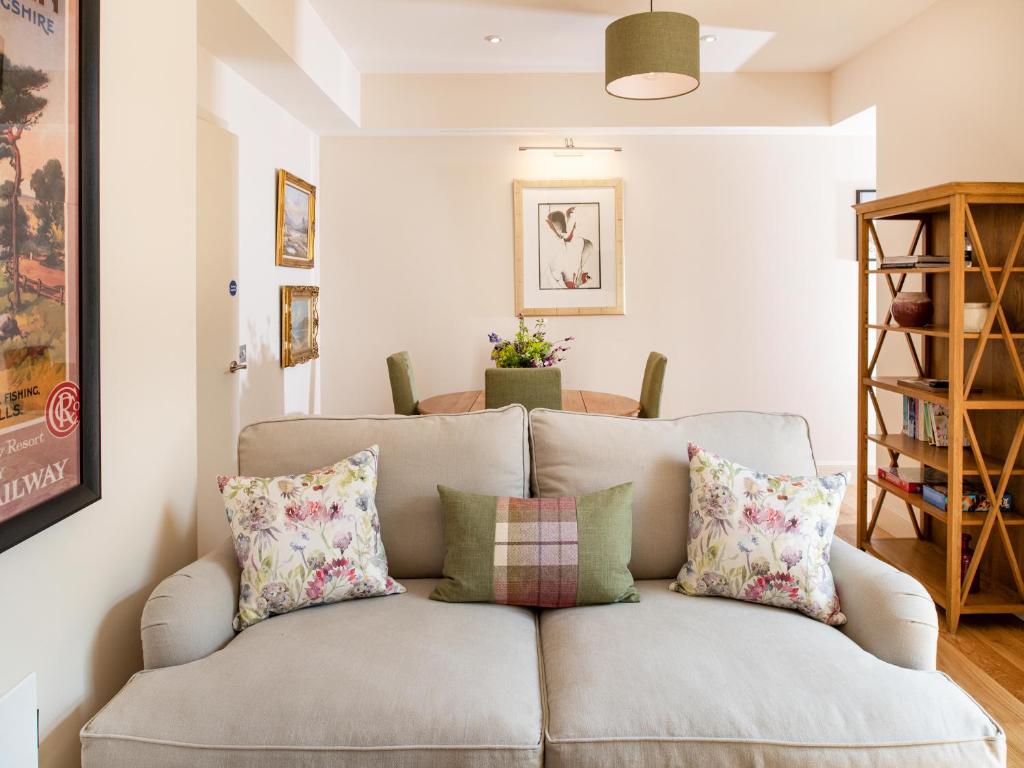 a living room with a couch with pillows at Courtyard - Uk7554 in Inverness