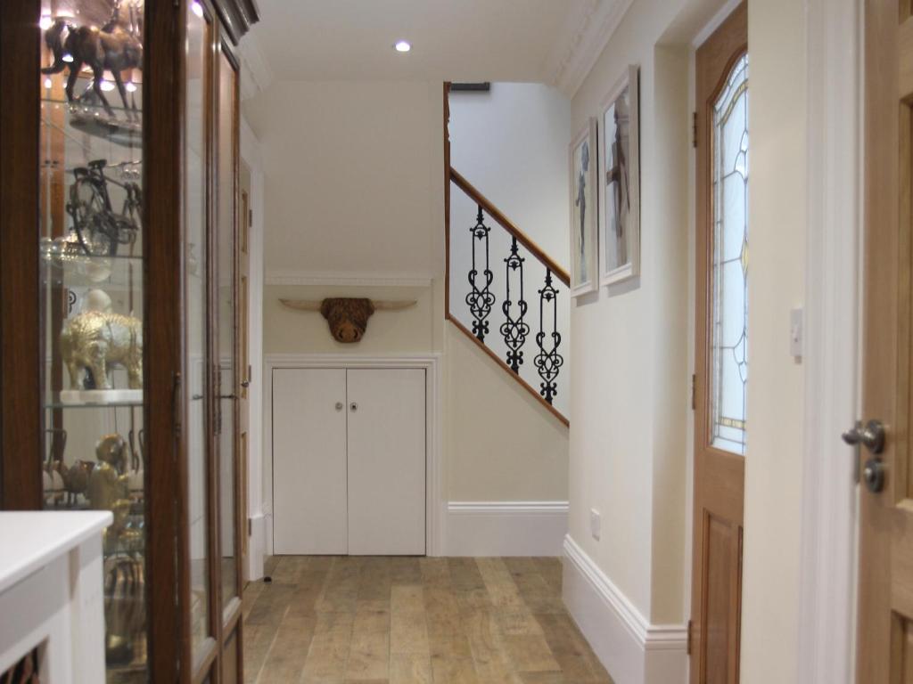 a hallway of a home with white walls and a staircase at Clan Young Suite in Berwick-Upon-Tweed
