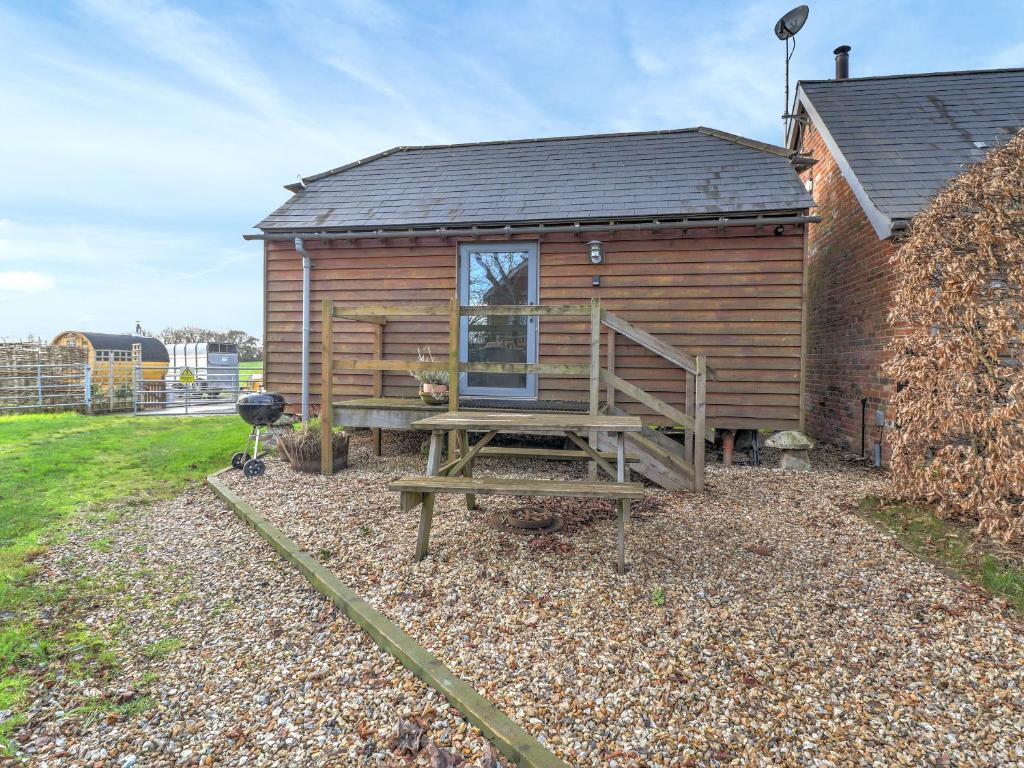 a log cabin with a wooden staircase and a deck at Staddlestone Barn - Ukc8984 in Romsey