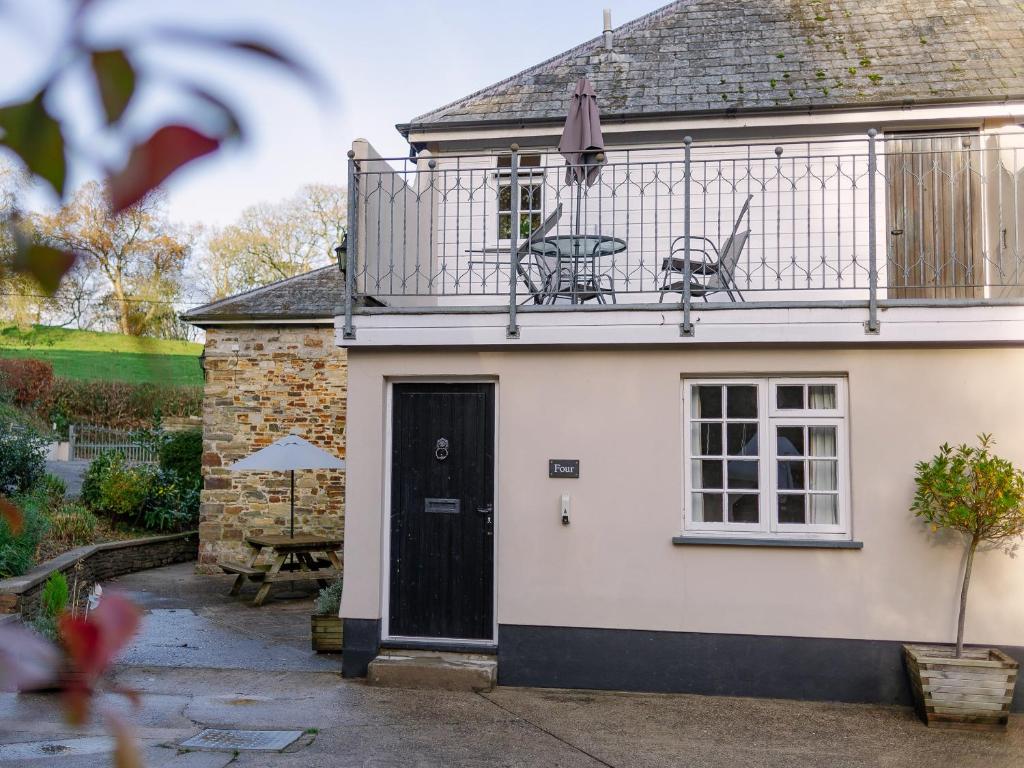 a white house with a balcony with two chairs on it at Number Five - Ukc4967 in Tawstock