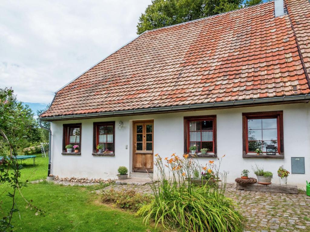 a white house with a red roof at Holiday home in Herrischried with garden in Herrischried