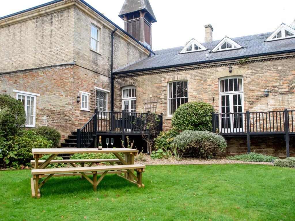 a picnic table in front of a brick building at Langetot in Bury Saint Edmunds
