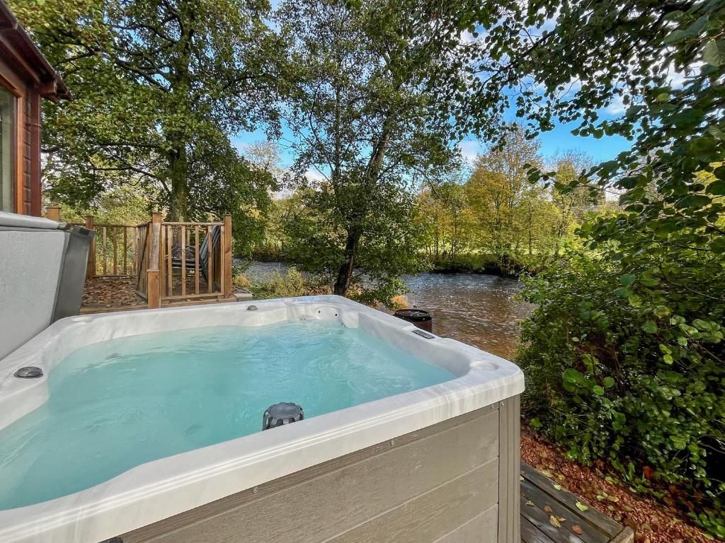 a jacuzzi tub with a view of a river at The Ardle in Crieff