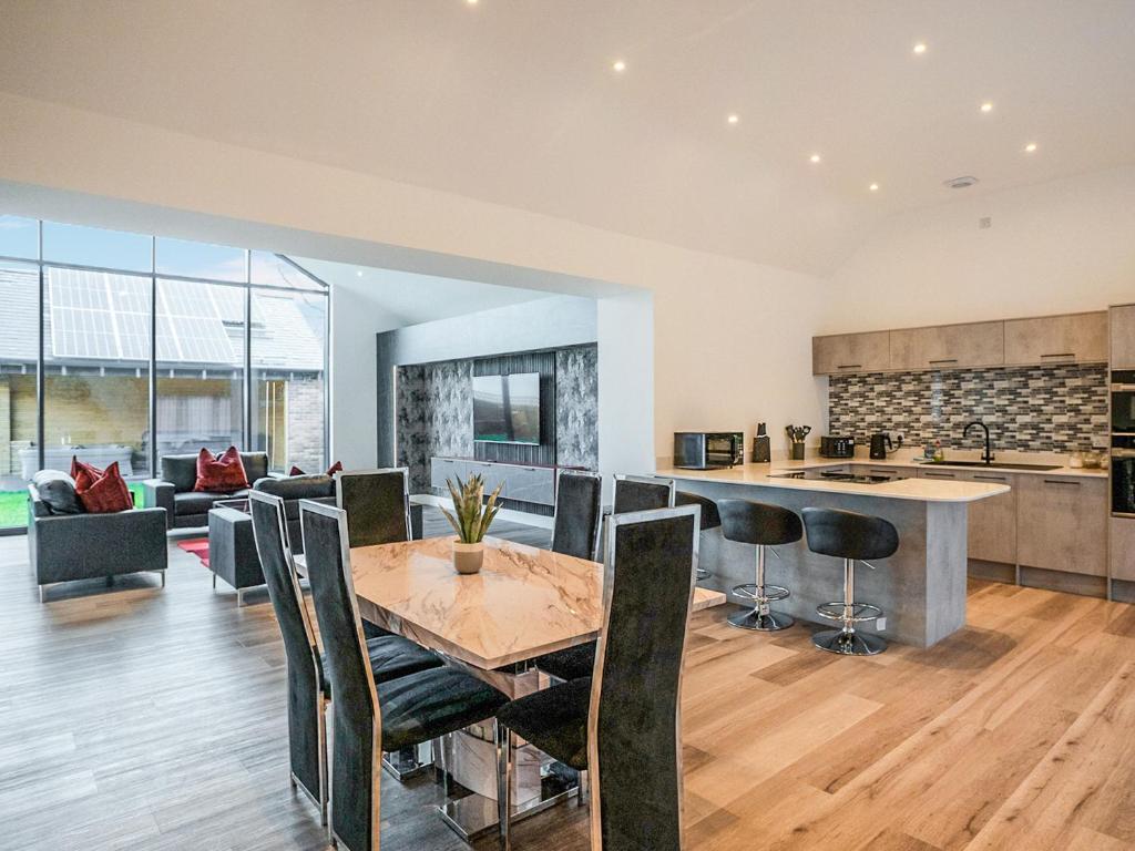 a kitchen and living room with a table and chairs at 13 Shearling - Ukc8974 in Warkworth