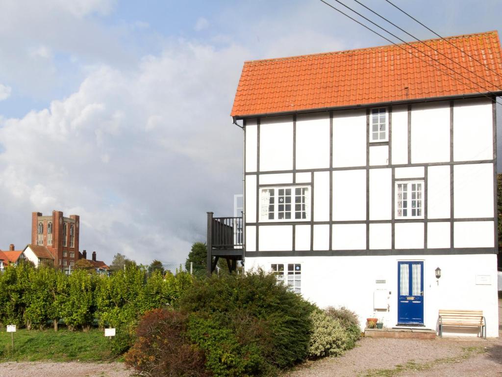 a white house with an orange roof at 1 Bell Lodge in Thorpeness