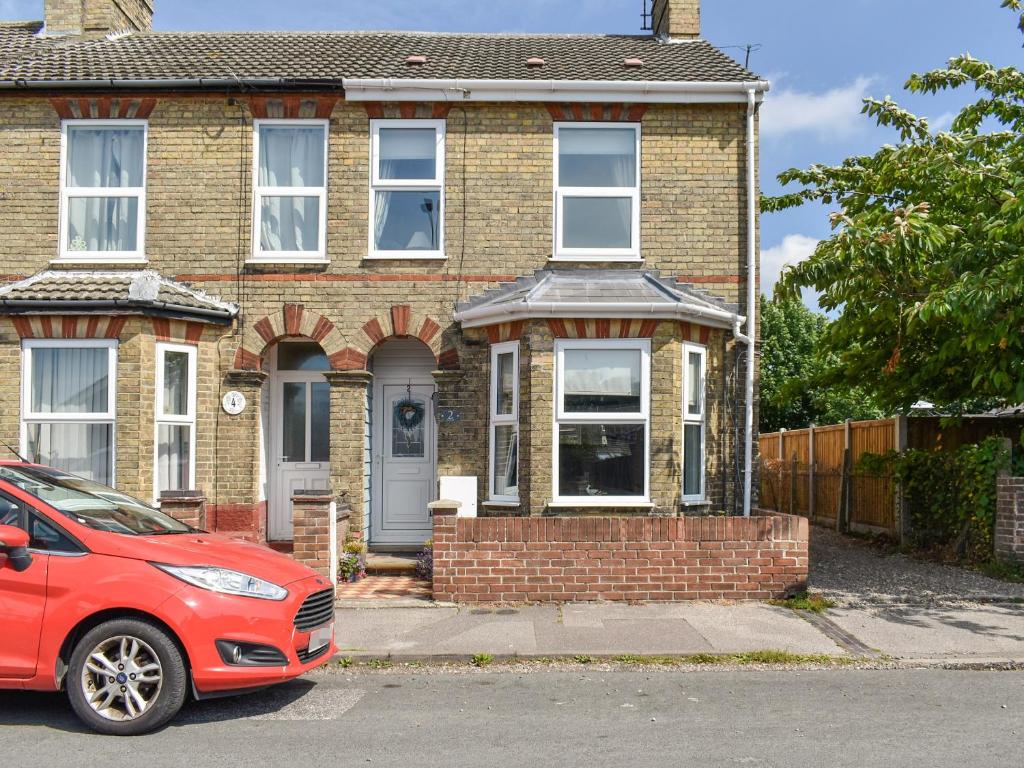 a red car parked in front of a brick house at Avocet - Ukc5446 in Pakefield