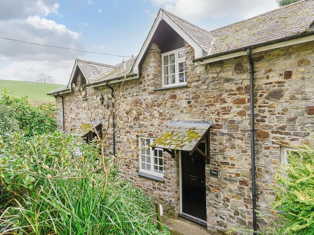 an old stone house with a black door at Number Two - Ukc4964 in Tawstock