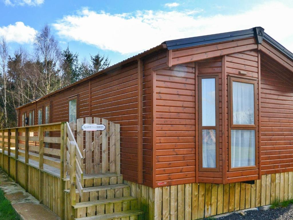 a small wooden cabin with a staircase and a fence at Jessie's Corner - Ukc5509 in West Thirston