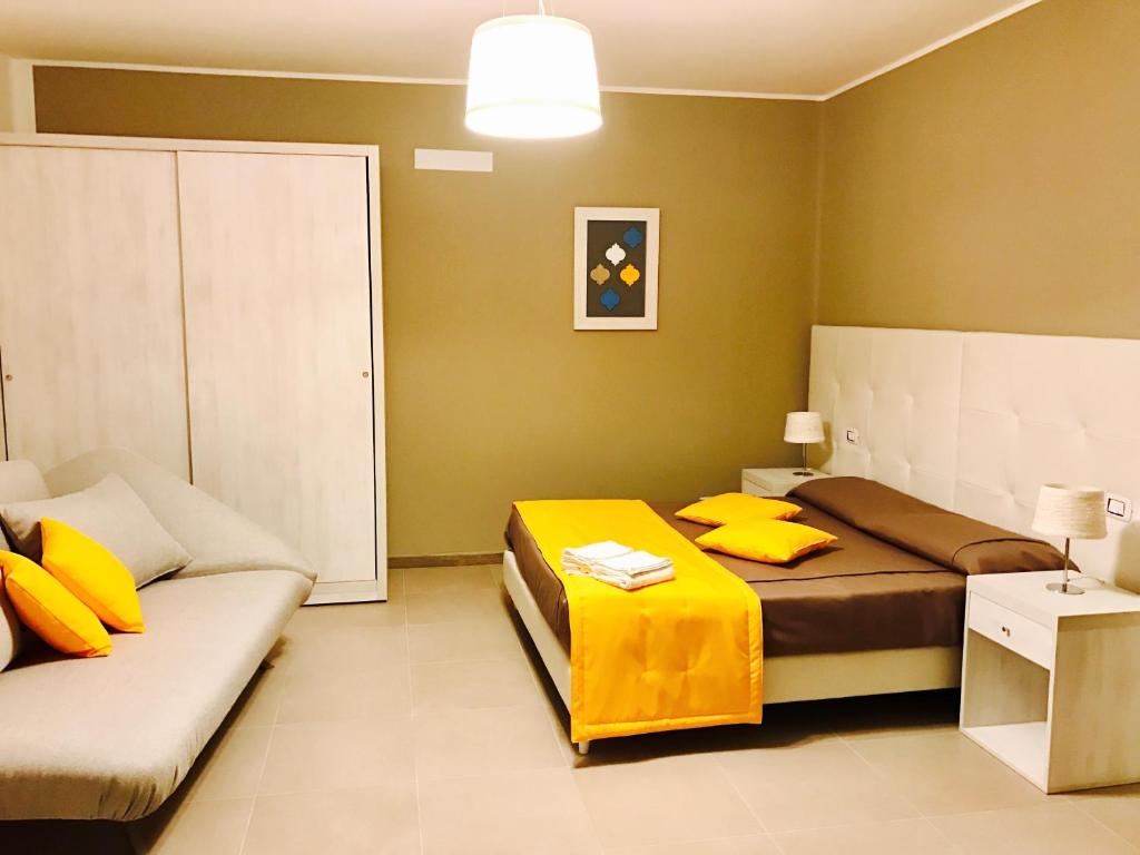 a bedroom with a bed and a couch in it at B&B Le Residenze in Altamura