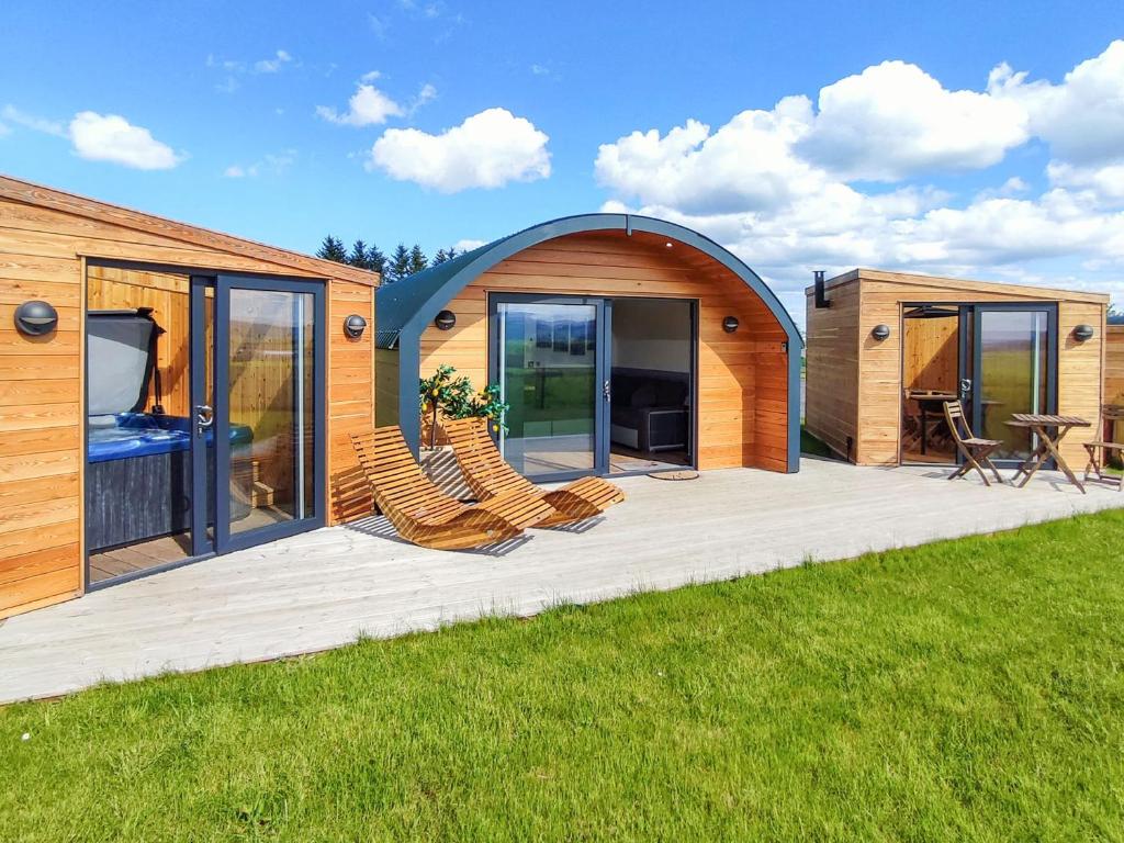 a circular house with chairs on a deck at Knockan - Ukc6026 in Newmill