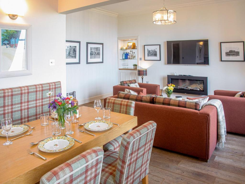 a dining room with a table and chairs at The Golf Place in St. Andrews