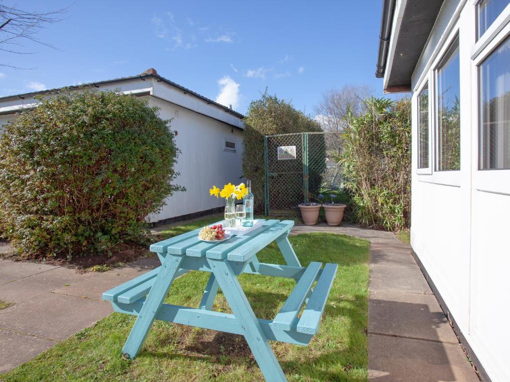 a blue picnic table on the grass in a yard at 310 The Cove - Ukc5025 in Dawlish