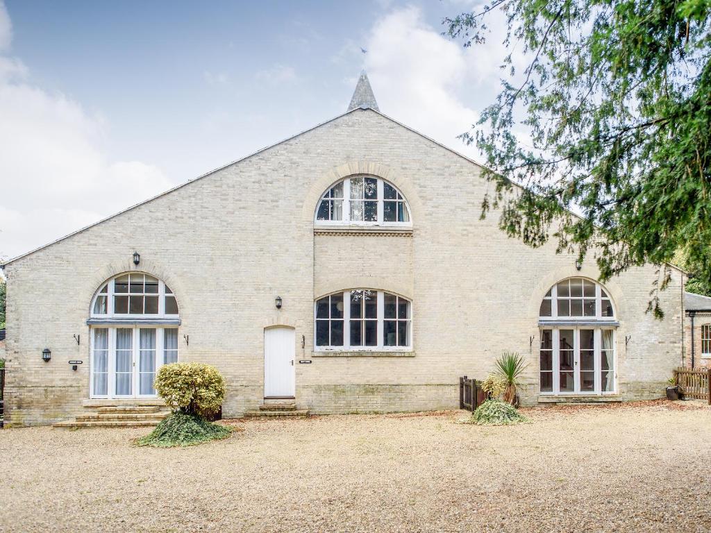 a large white brick church with windows at The Amherst House in Bury Saint Edmunds