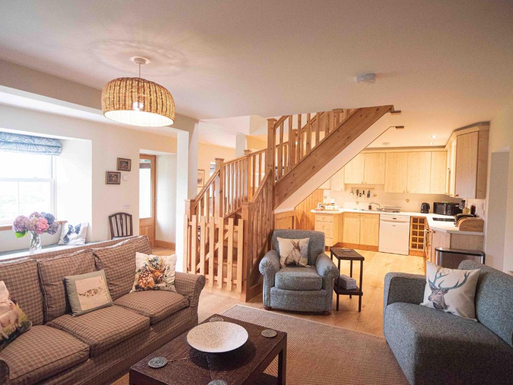 a living room with a couch and a staircase at Steading Cottage - Ukc5957 in Port Appin
