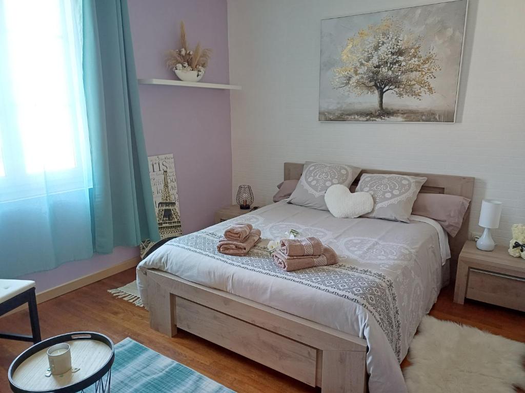 a bedroom with a bed with two teddy bears on it at L'étoile du matin in Terville