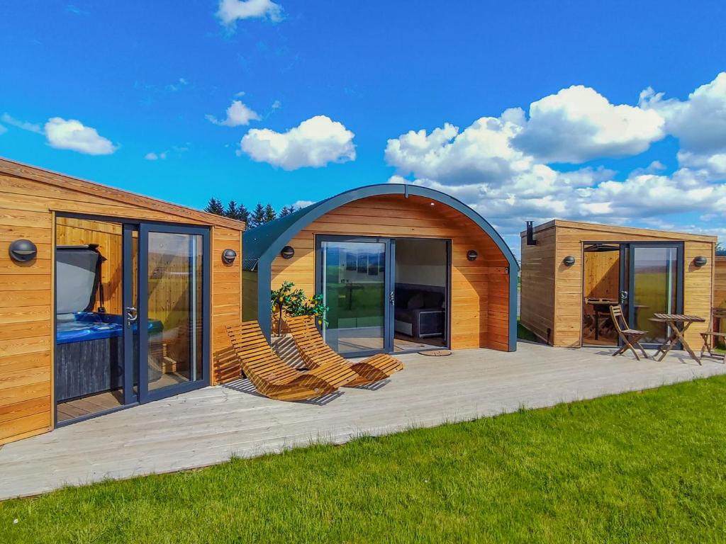 a modular house with chairs on a deck at Meikle Balloch - Ukc6069 in Newmill