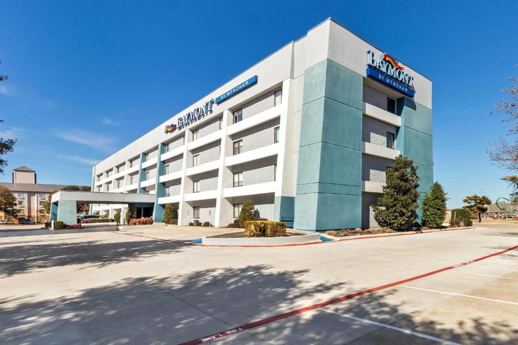 a building with a sign on the front of it at Baymont by Wyndham Arlington At Six Flags Dr in Arlington