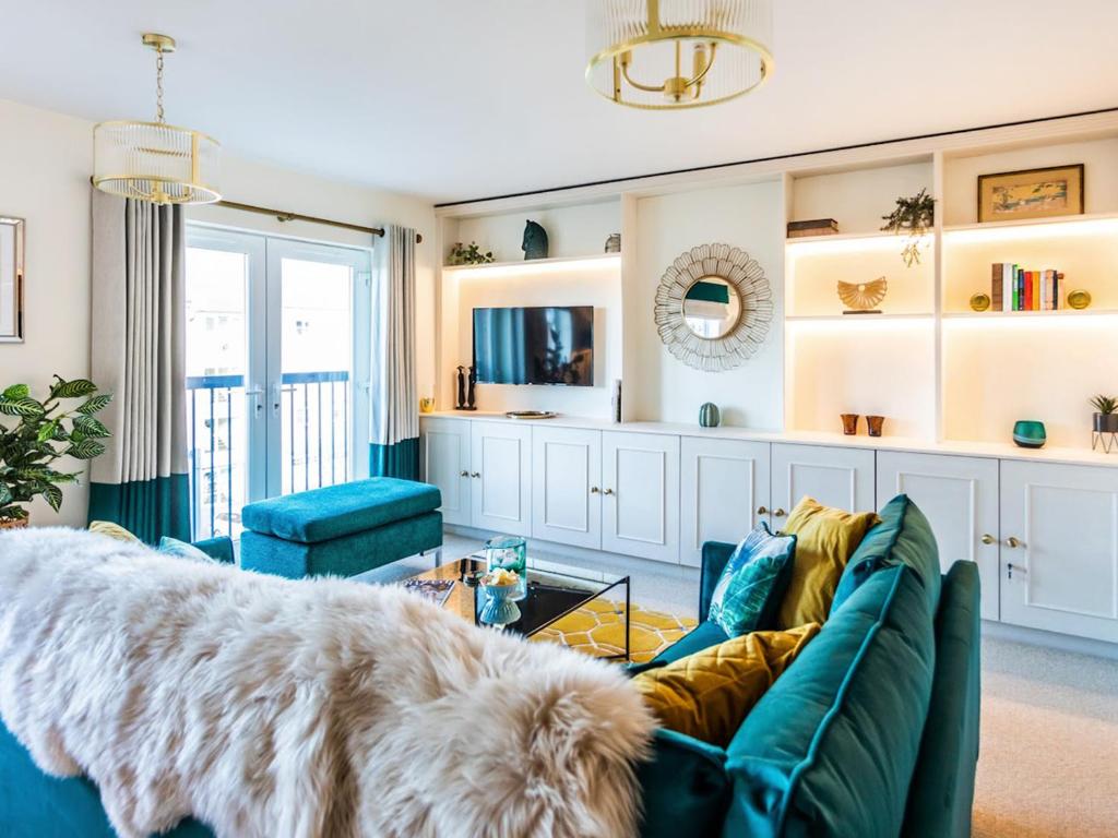 a living room with a blue couch and a dog at The Wharf in Warwick