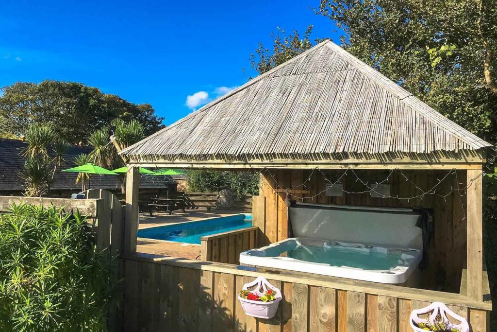 a wooden dog house with a swimming pool at Fistral Cottage - Cwc46839 in Perranporth