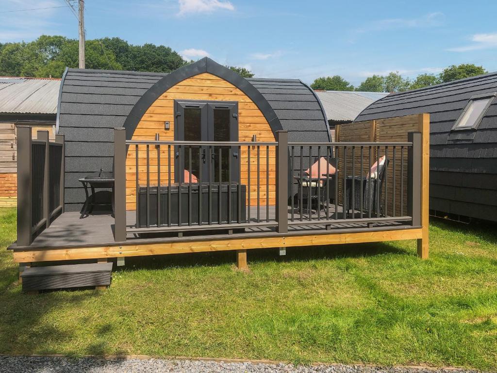 a large wooden deck with a table and chairs at Hornbeam - Uk44262 in Waldron