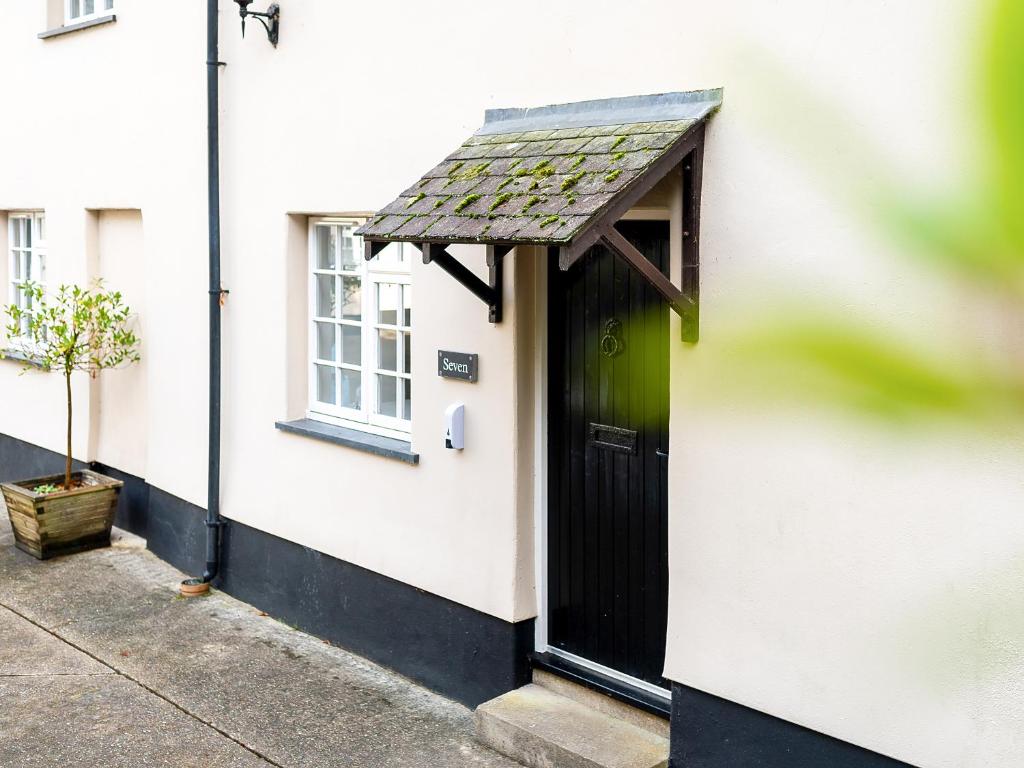 a small white house with a green door at Number Seven - Ukc4969 in Tawstock