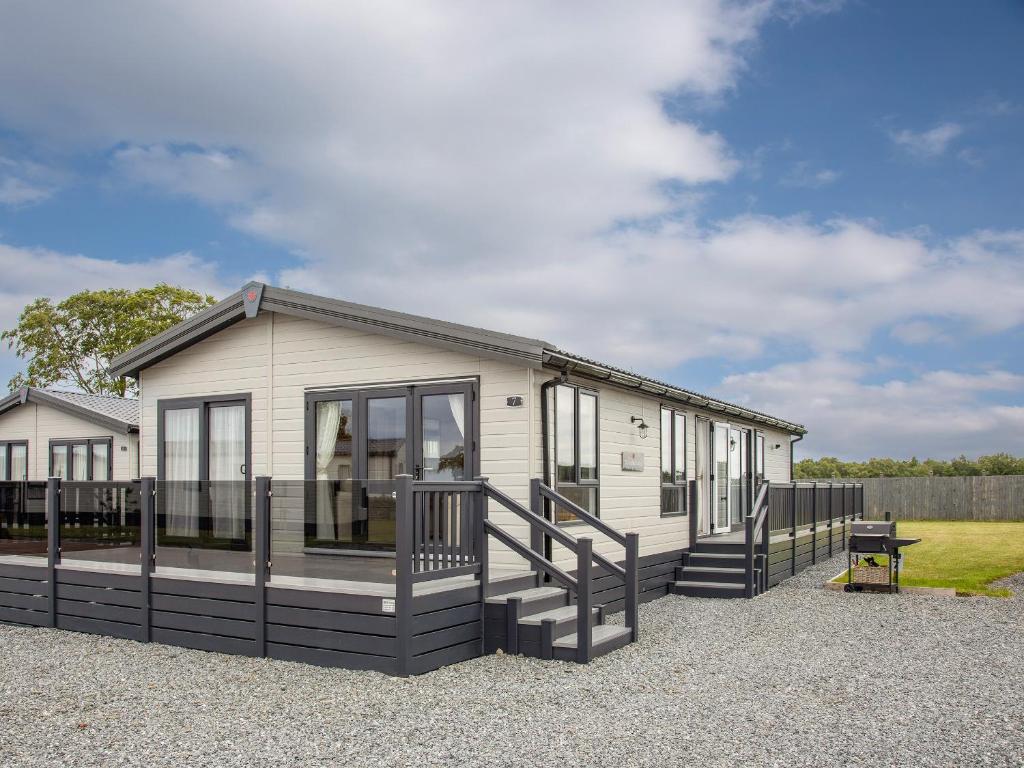 a mobile home with a porch and stairs at Rivendale 8 in St. Andrews