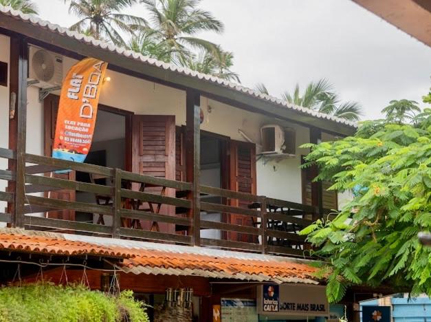 a building with an orange sign on the side of it at Flat dboa in Jericoacoara