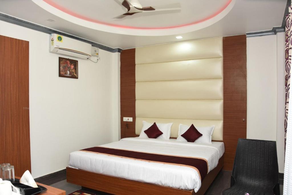a hotel room with a bed and a ceiling at Sea Shore In in Port Blair