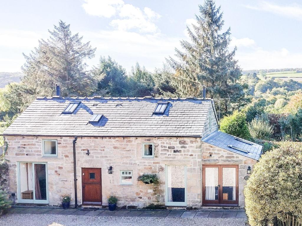a stone house with skylights on top of it at Acorn Cottage in Ashover