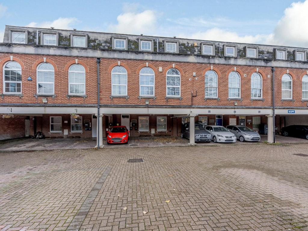 a large brick building with cars parked in front of it at 4 Eastgate - Uk34281 in Andover