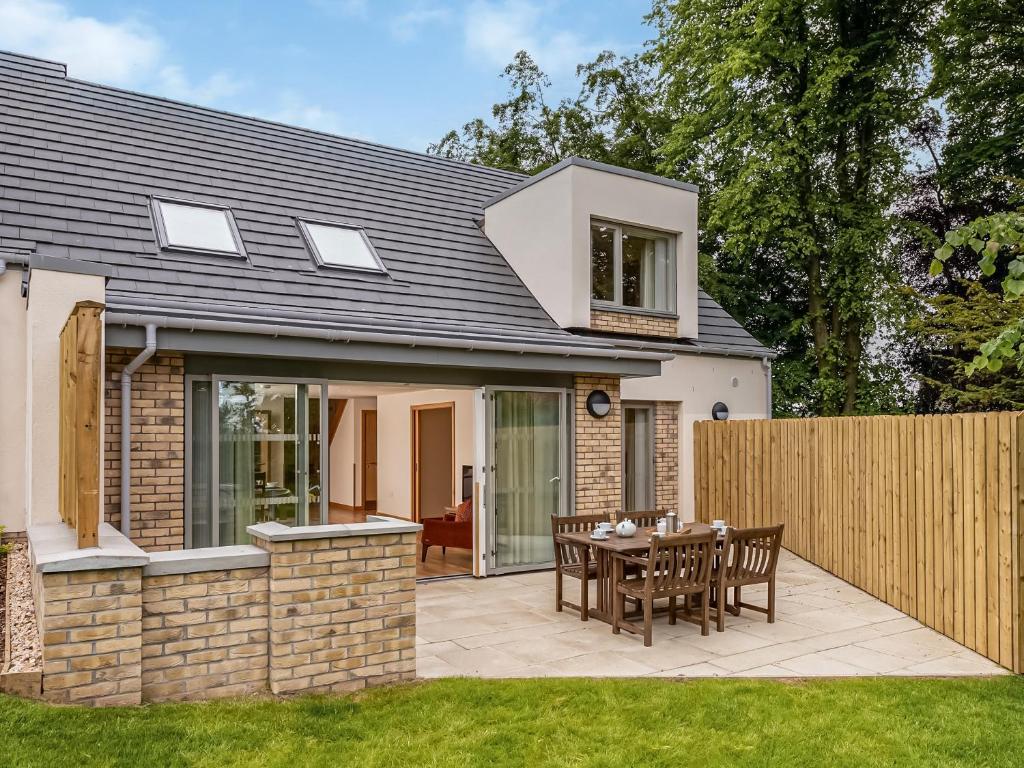 an extension to a house with a patio at Durham Lodge - Ukc5799 in Lundin Links