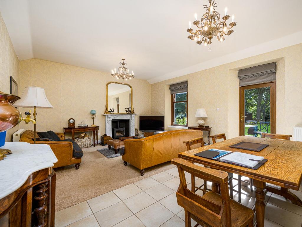 a living room with a table and a dining room at The Servant's Hall - Ukc6964 in Carnoustie