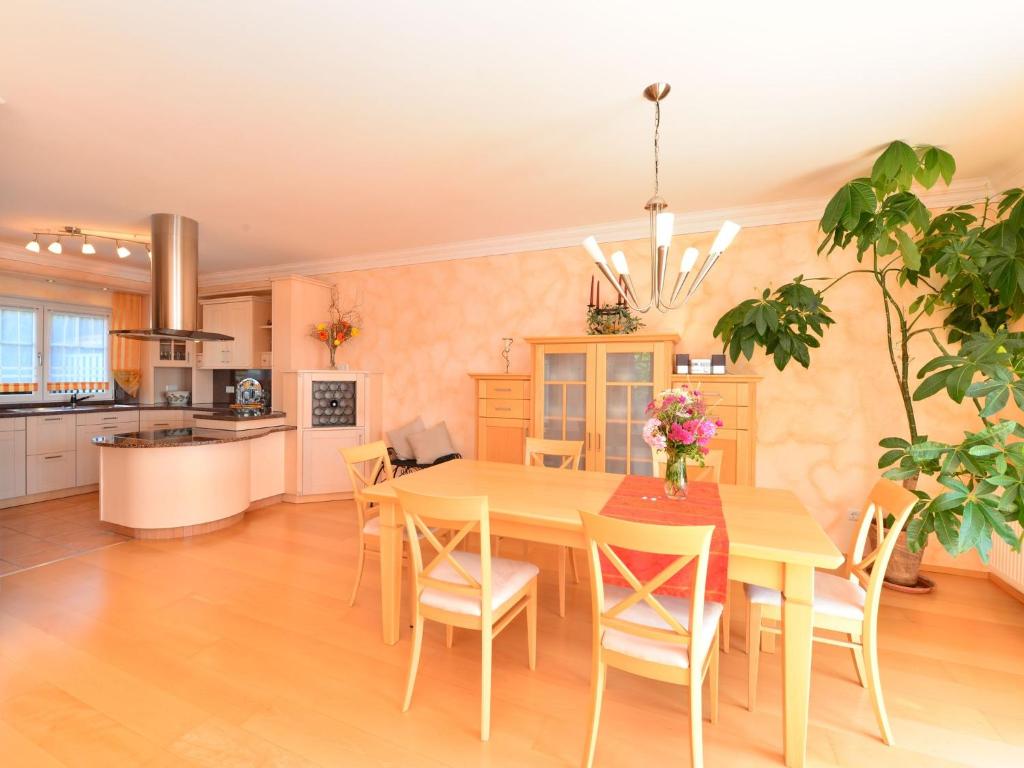 a kitchen and dining room with a table and chairs at Apartment near the river in Deggendorf Bavaria in Deggendorf