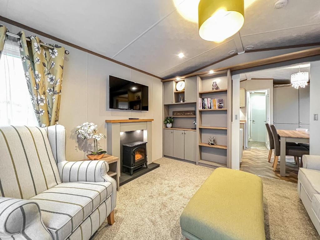 a living room with a couch and a fireplace at Abington 14 in St. Andrews