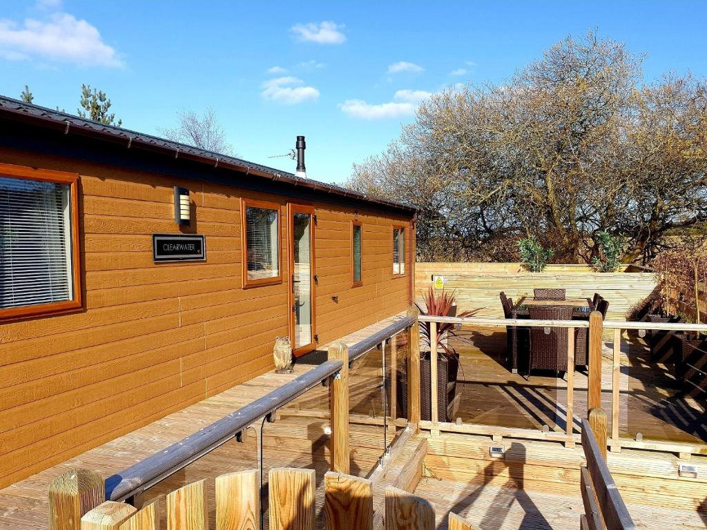 a log cabin with a porch and a deck at Serenity Lodge-Uk3456 in Felton