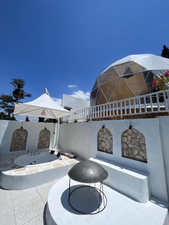 a patio with a chair and a tub at Naima 3 in Panjadakan