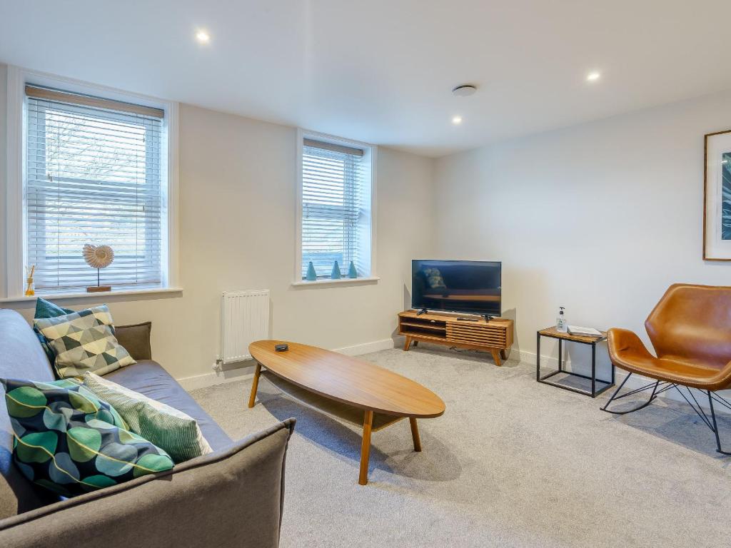 a living room with a couch and a table and a tv at 6 Eastgate -Uk34289 in Andover