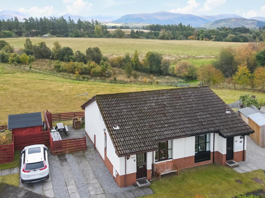 an aerial view of a house with a car parked outside at Dalfaber View-Ukc5054 in Aviemore