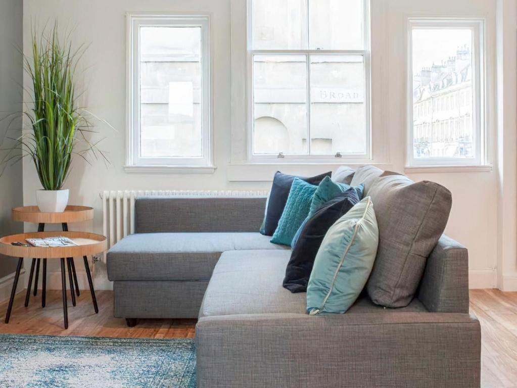 a living room with a couch with pillows on it at Broad Street in Bath