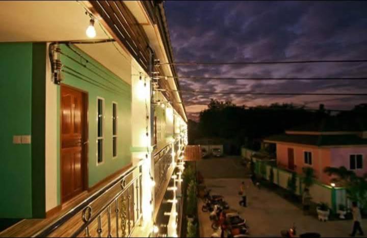 a view of a street at night from a building at สายป่านอาพาร์ทเม้นท์ in Ban Bung Sam Phan Nok